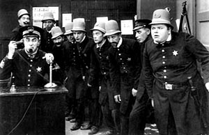 The Keystone Kops. Ford Sterling on phone. Fatty Arbuckle, far right.